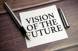 Vision Of The Future words on notebook and wooden background photo