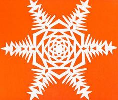 white snowflake on orange paper photo