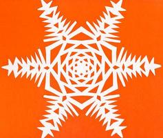 white snowflake on orange paper photo