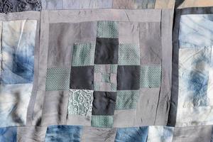 fragment of hand-crafted patchwork quilt photo