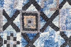 wrinkled hand-stitched patchwork quilt photo