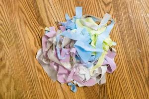 top view of pile of multicolored scraps of fabrics photo