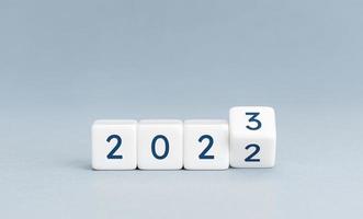 Change from 2022 to 2023 on cube blocks on blue background. New year is coming concept. Copy space photo