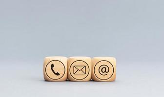 Contact icons on wooden blocks on gray background. Copy space photo