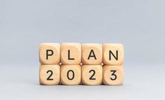 Plan 2023 message on wooden block shape on blue background. Copy space photo