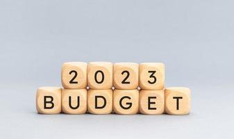 2023 budget message on wooden cube shape on blue background. Copy space photo