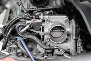 Close up old throttle Body of car in engine room with dust and Soot for repair and clean in process with engine room photo