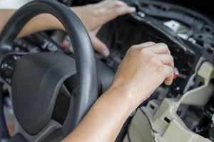 Close up hand Technician use screw driver remove and check car speedometer check the point of damage and check for repair in car service shop photo