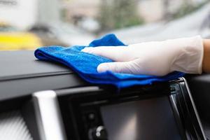 Car care workers wash, spray and clean the car. photo