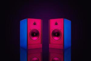Two stereo speakers with neon light on dark background photo