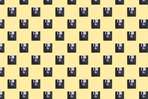 Floppy diskette pattern on yellow background photo