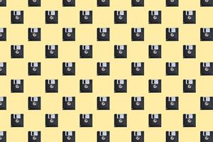 Floppy diskette pattern on yellow background photo