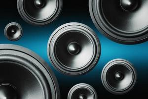 Many audio speakers on dark background photo