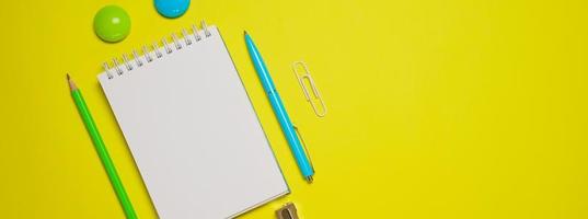 Office accessories on yellow background with copy space. View from above. Back photo