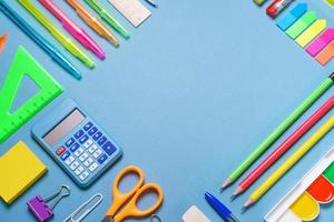 Frame with school supplies on a white background. Flat dip, top view. photo