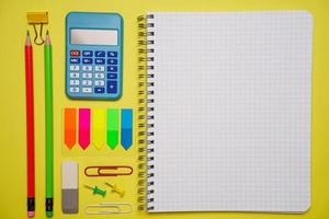 Notebook with a pen and colorful notes on a blue and orange background. photo