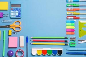 Frame with school supplies on a white background. Flat dip, top view. photo