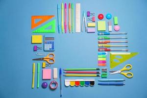 Calculator, stationery accessories on blue background with copy space. Look photo