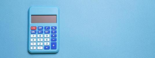 Modern calculator, business and financial accounting concept on blue background photo