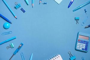 School objects, office supplies, tools and accessories isolated on blue photo