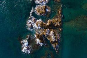 Aerial view of rocks under turquoise water photo