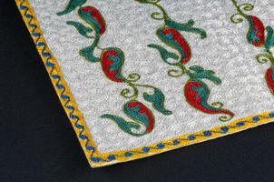 A closeup shot of national ornaments and patterns of Central Asia on a piece of fabric photo