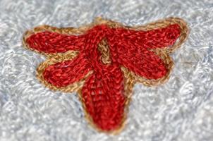 A closeup shot of national ornaments and patterns of Central Asia on a piece of cloth photo