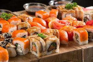 A closeup shot of a sushi set on a wooden plate photo