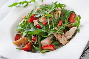 Chicken salad with arugula and strawberries photo