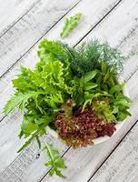 Variety fresh organic herbs  on wooden background in rustic style photo