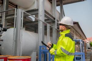 Engineers work place to keep liquid helium,preventive maintenance schedule checking,Thailand people,Technicians and engineers discuss work together. photo