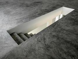 una escalera de hormigón abierta que conduce al piso inferior foto