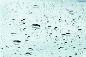 Drops of water and water beads on clear glass. photo