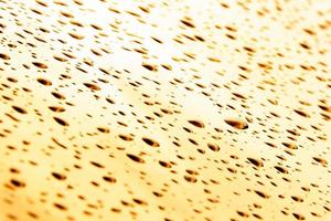 Drops of water and water beads on clear glass. photo