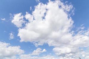 white clouds, floating and forming with a blue sky in the background photo