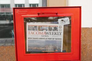 Tacoma, Washington, USA. March 2021. Tacoma Weekly newspaper in the red box photo