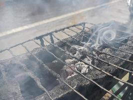 The Flaming Charcoal Grill smoked. Close Up, Front View. photo