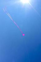 Pink kite flying with blue sky in Germany. photo