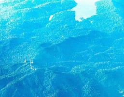 Flying above the clouds and the landscape airport over Singapore. photo