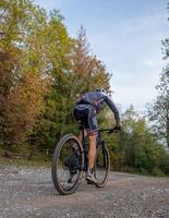 Italy 2022 Cyclist traveling along a dirt road in the mountains photo