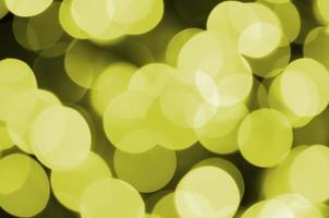 Bokeh effect golden yellow defocused light background. Christmas Lights Concept photo