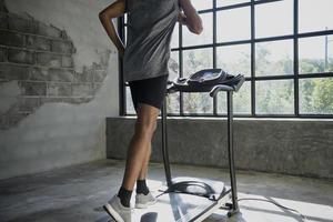 A man walking and exercising on a treadmill. photo