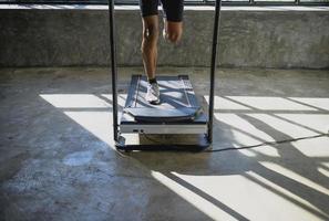 A man walking and exercising on a treadmill. photo