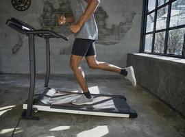 A man walking and exercising on a treadmill. photo