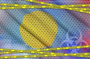 Palau flag and Covid-19 quarantine yellow tape. Coronavirus or 2019-nCov virus concept photo