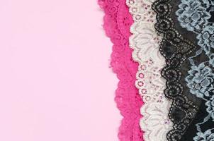 White, black and pink women underwear with lace on pink background with copy space. Advertising for shop of beautiful and comfortable women underwear photo