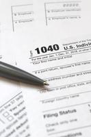 The pen lies on the tax form 1040 U.S. Individual Income Tax Return. The time to pay taxes photo
