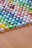 A pattern from a many nozzles from a paint sprayer for drawing graffiti, smeared into different colors. The plastic caps are arranged in many rows forming the color of the rainbow photo