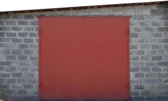 The texture of a painted metal gate from a brick garage photo