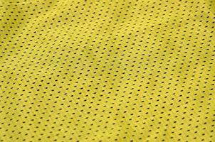 Texture of sportswear made of polyester fiber. Outerwear for sports training has a mesh texture of stretchable nylon fabric photo